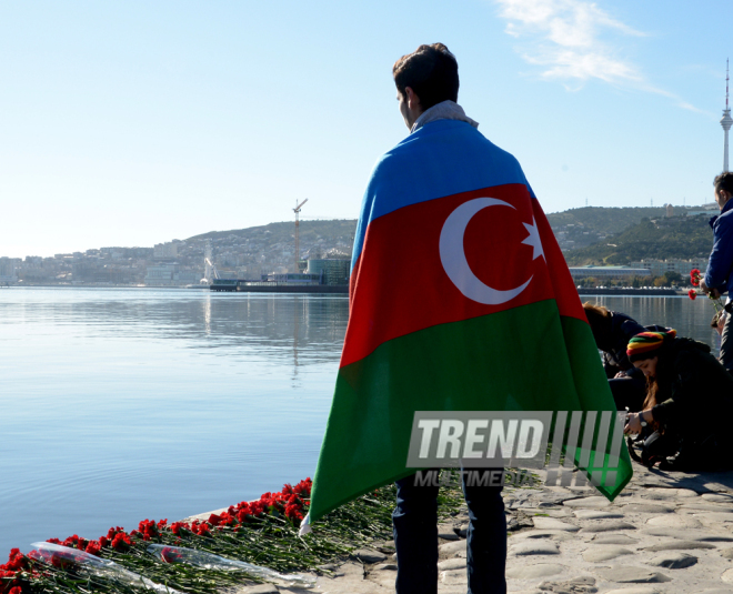 Baku residents bringing flowers to Seaside Boulevard to honor missing oil workers.  Azerbaijan, Dec.07, 2015